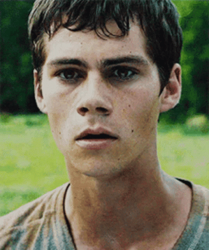 A Close Up Of A Young Man 'S Face With A Blurred Background GIF