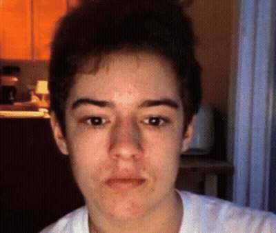 A Close Up Of A Young Man 'S Face With A Blurred Background GIF