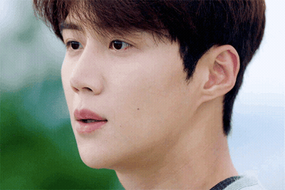 A Close Up Of A Young Man 'S Face With A Gray Shirt On GIF