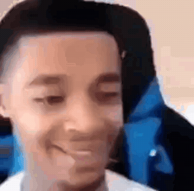 A Close Up Of A Young Man 'S Face With A Hat On . GIF