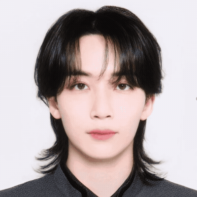 A Close Up Of A Young Man 'S Face With A Ponytail GIF