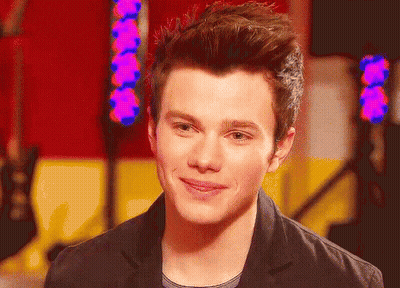 A Close Up Of A Young Man 'S Face With A Purple Light Behind Him GIF