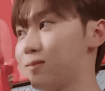 A Close Up Of A Young Man 'S Face With A Red Background Making A Face . GIF