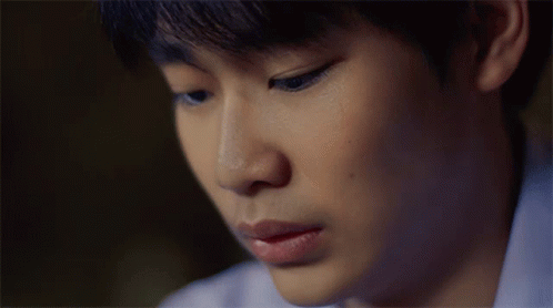 A Close Up Of A Young Man 'S Face With A Sad Look On His Face GIF