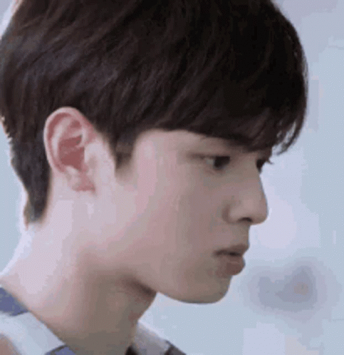 A Close Up Of A Young Man 'S Face With A Serious Expression On His Face . GIF