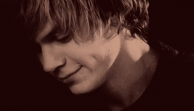 A Close Up Of A Young Man 'S Face With A Serious Look On His Face In A Black And White Photo . GIF