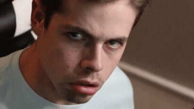 A Close Up Of A Young Man 'S Face With A Serious Look On His Face GIF