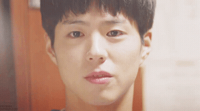 A Close Up Of A Young Man 'S Face With A Slight Smile On His Face GIF