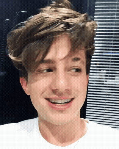 A Close Up Of A Young Man 'S Face With A Smile GIF