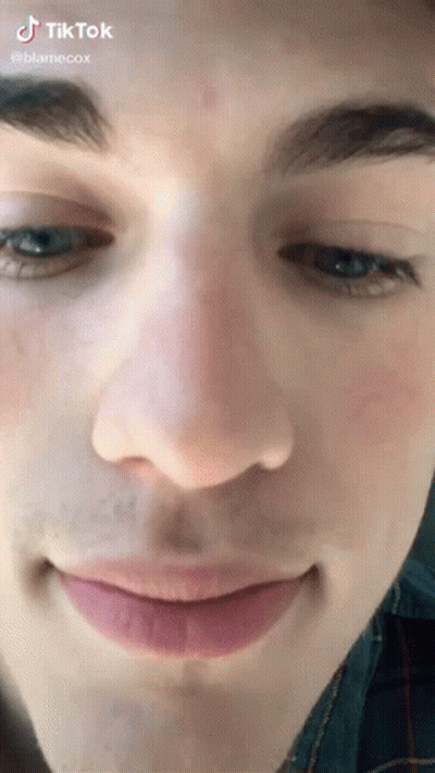 A Close Up Of A Young Man 'S Face With A Smile On His Face . GIF