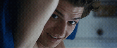 A Close Up Of A Young Man 'S Face With A Smile On His Face GIF
