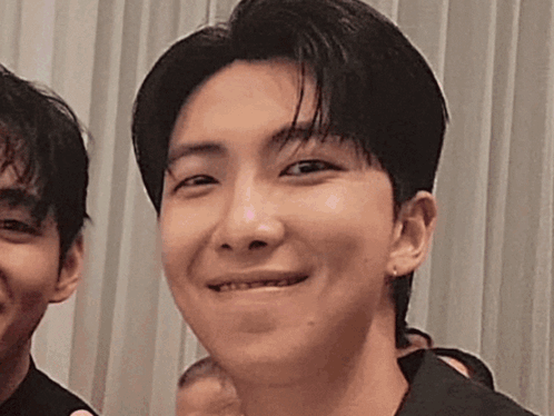 A Close Up Of A Young Man 'S Face With A Smile On His Face . GIF