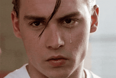 A Close Up Of A Young Man 'S Face With A Tear Coming Out Of His Eye GIF