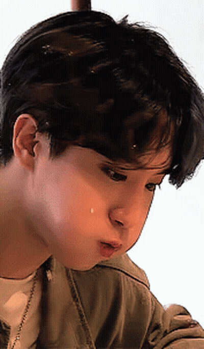 A Close Up Of A Young Man 'S Face With A Tear Coming Out Of His Nose GIF