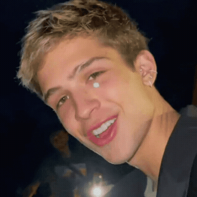 A Close Up Of A Young Man 'S Face With A Tear Coming Out Of His Nose . GIF