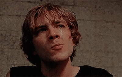 A Close Up Of A Young Man 'S Face With A Tear Running Down His Cheek . GIF