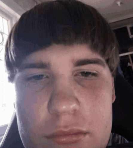 A Close Up Of A Young Man 'S Face With A Very Serious Look On His Face . GIF