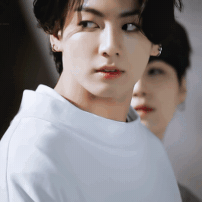 A Close Up Of A Young Man 'S Face With A Woman Behind Him . GIF