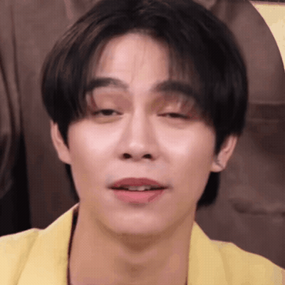 A Close Up Of A Young Man 'S Face With A Yellow Jacket On . GIF