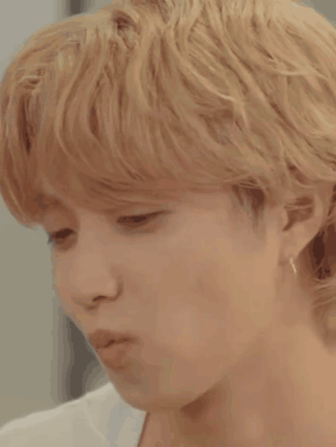 A Close Up Of A Young Man 'S Face With Blonde Hair . GIF