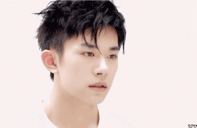 A Close Up Of A Young Man 'S Face With Chinese Writing Below Him GIF