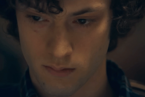 A Close Up Of A Young Man 'S Face With Curly Hair GIF