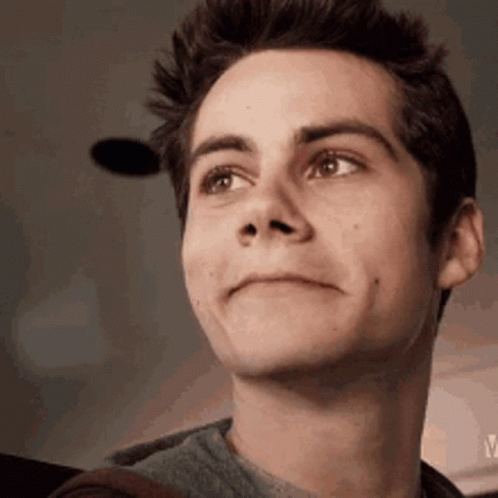 A Close Up Of A Young Man 'S Face With His Eyes Closed And A Smile On His Face . GIF
