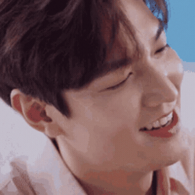 A Close Up Of A Young Man 'S Face With His Eyes Closed And His Mouth Open . GIF