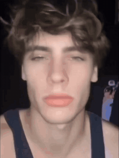 A Close Up Of A Young Man 'S Face With His Eyes Closed And His Mouth Open . GIF
