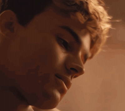 A Close Up Of A Young Man 'S Face With His Eyes Closed And His Mouth Open GIF