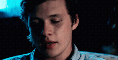 A Close Up Of A Young Man 'S Face With His Eyes Closed In A Dark Room . GIF