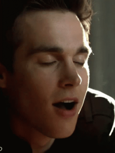 A Close Up Of A Young Man 'S Face With His Eyes Closed GIF