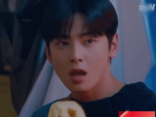 A Close Up Of A Young Man 'S Face With His Mouth Open . GIF
