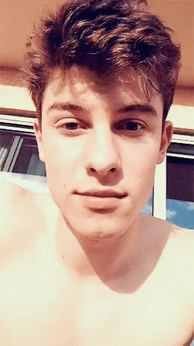 A Close Up Of A Young Man 'S Face With His Shirt Off GIF