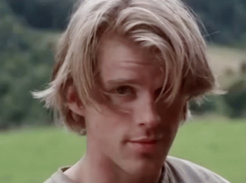 A Close Up Of A Young Man 'S Face With Long Blonde Hair GIF