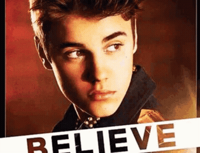 A Close Up Of A Young Man 'S Face With The Word Believe Written On It . GIF