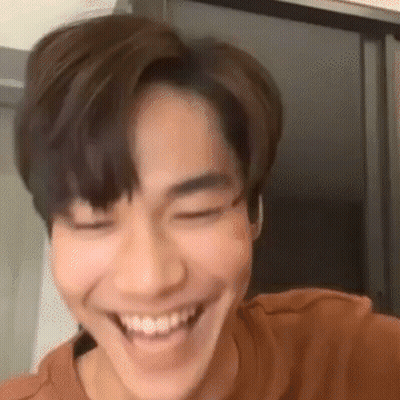 A Close Up Of A Young Man Smiling With His Eyes Closed And His Mouth Open . GIF