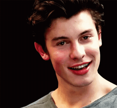 A Close Up Of A Young Man Smiling With His Mouth Open . GIF