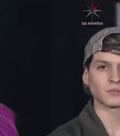 A Close Up Of A Young Man Wearing A Baseball Cap And A Black Shirt . GIF