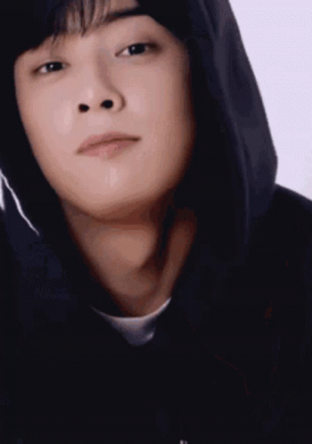 A Close Up Of A Young Man Wearing A Black Hoodie . GIF