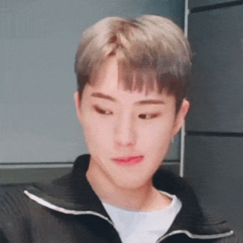 A Close Up Of A Young Man Wearing A Black Jacket And A White Shirt Making A Funny Face . GIF