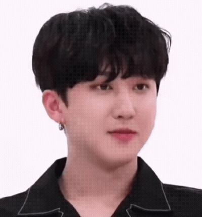 A Close Up Of A Young Man Wearing A Black Shirt And Earring . GIF