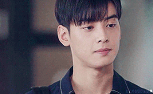 A Close Up Of A Young Man Wearing A Black Shirt And Looking At The Camera . GIF