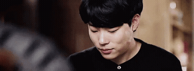 A Close Up Of A Young Man Wearing A Black Shirt Looking Down . GIF