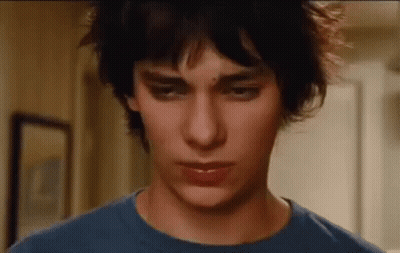 A Close Up Of A Young Man Wearing A Blue Shirt . GIF