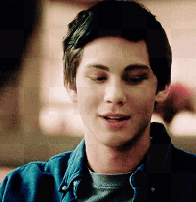 A Close Up Of A Young Man Wearing A Denim Shirt GIF