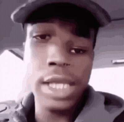 A Close Up Of A Young Man Wearing A Hat And A Hoodie . GIF