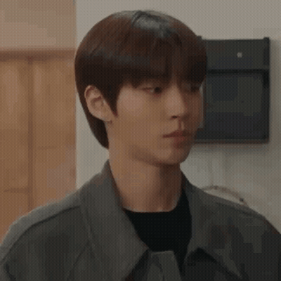 A Close Up Of A Young Man Wearing A Jacket And A Black Shirt Looking At The Camera . GIF