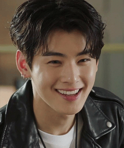 A Close Up Of A Young Man Wearing A Leather Jacket Smiling GIF