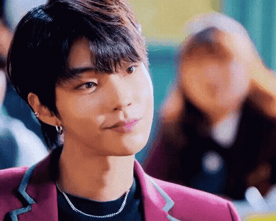 A Close Up Of A Young Man Wearing A Purple Jacket And A Necklace . GIF